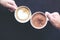 Top view image of man and woman`s hands holding coffee and hot chocolate cups