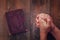 Top view image of mans hands folded in prayer next to prayer book. concept for religion, spirituality and faith