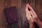 Top view image of mans hands folded in prayer next to prayer book. concept for religion, spirituality and faith