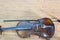 Top view image, old brown wooden violin resting on a wooden floor  Copy free space