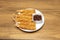 Top view image of raw Italian pasta, wheat flour, cherry tomatoes and bamboo table on black background