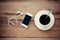 Top view image of smartphone with blank screen headphones and coffee cup..