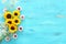 Top view image of sunflowers over blue wooden background