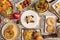 top view image of typical dishes of Spanish gastronomy. Iberian ham croquettes, stewed pork cheek, potato tortilla, Squid in ink