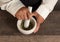 Top view image of woman\'s hands using a mortar in the kitchen.