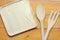 Top view image of wooden spoon, fork and blank tray placed on wooden table, Different wooden kitchen tools with copy