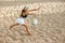 Top view image of young woman playing paddle, beach tennis, hitting ball with racket in motion. Competition