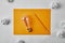 top view of incandescent lamp on blank yellow paper with pencil surrounded with crumpled papers