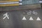 Top view of the intersection of the sidewalk, bike path and road, marked with signs and different colors