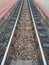 Top view iron and stone rustic railroad tracks selectable focus image for train travel concept background.