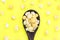 Top view isolated salted popcorn mix with cheese mushroom popcorn on wood ladle on yellow table background, movie cinema time