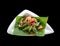 Top view of isolated spicy spaghetti seafood with crispy basil on banana leaf. With clipping path