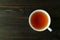 Top View of  Japanese Roasted Barley Tea or Mugicha on Dark Color Wooden Table with Copy Space