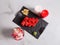 Top view of Japanese sushi roll with salmon and flying fish roe. rose petals and candles near served dish on marble background.