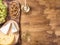 Top view of a jar with honey served with fresh grapes, chees and wolnuts on rustic wooden table