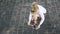 Top view of a jogger woman tying her shoelace and starting to run outside