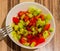 Top view of juicy salad of tomatoes and cucumbers in a white bowl