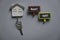 Top view of key holder with key and wooden notice board with question rent or sell