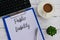 Top view of keyboard.coffee,plant,pen,clipboard and paper written with Public Liability