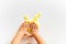 Top view of kid`s hand and yellow slime on white background. Toddler activity. Motor skills. Homemade clay