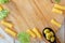 Top view of kitchen board with raw ingredients of italian tortiglioni pasta.