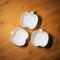 Top view of kitchenware, 3 white ceramic bowls of apple shape design on wood dining table background
