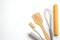 Top view kitchenware wooden rolling pin, wooden spatula and egg beater on white background.