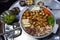 Top view of Korean traditional food, beef and pork intestines, Gopchang, on a hot coals and metal table with green onion side dish