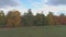 Top view of the landscape of central Russia with trees that are covered with autumn foliage.