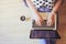 Top view of laptop in girl\'s hands sitting on a floor