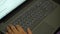 Top view of a laptop keyboard with female hands. The image is out of focus. The concept of remote work