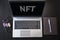 Top view of laptop with text NFT. Non-fungible token