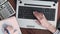 Top view on laptop. woman`s hands show on computer screen. girl working in a modern office