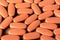 Top view of a large number of brown pills. Background for design