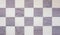 Top view or lay flat shot of vintage checkerboard shows beautiful pattern on square in white and purple colors. It is repeating