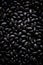 Top view of a layer of black beans, dry legumes