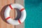 Top view of lifebuoy lying near the swimming pool