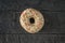 Top view of a light glazed doughnut on a wooden background