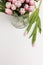 Top view light rosy tulips in glass vase