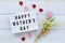 Top view lightbox with a sign HAPPY MOTHER`S DAY, rose petals and bouquet on a wooden background. Mother`s day concept