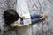 Top view of little girl doodling on the paper notebook sitting on bed at home. Preschool little girl in casual wearing is engaged