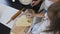 Top of view. Little girl with long hair in white dress makes dough for gingerbread cookies at home kitchen. The baby