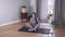 Top view long shot of relaxed Caucasian woman meditating indoors. Beautiful young woman practicing yoga at home
