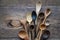 Top view lot of wooden spoons made of precious wood on wooden table, eco-friendly concept of cutlery, handmade tableware