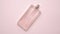 Top view of luxury bottle of perfume on pastel pink surface. Minimal composition. Flat lay