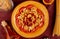 top view of macaroni pasta in plate with ketchup bucatini melted butter and vermicelli on bordo cloth background