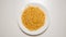 TOP VIEW: Macaroni on a white dish on a white table