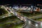 Top view of a major road junction in the city at night. The movement of cars in the night city. Light from vehicles and lanterns