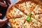 Top view of male hand take homemade caesar pizza on black background