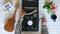 Top view on male hands turning on vintage gramophone at white table background. Arm of man putting stylus with needle on